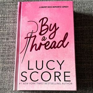 By a Thread by Lucy Score Hardcover w/sprayed edges and author signature